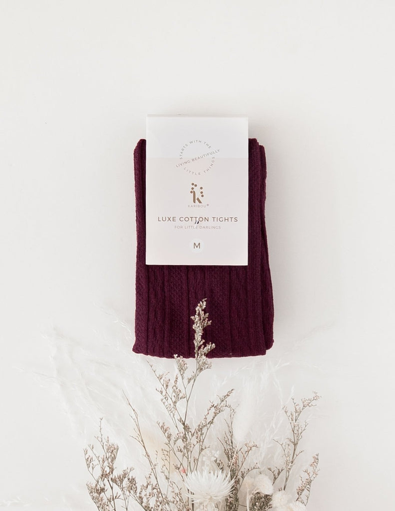 US stockist of Karibou Kids' Rosie Cozy Cable Knit Tights in Plum.  Made from a stretch cotton blend.