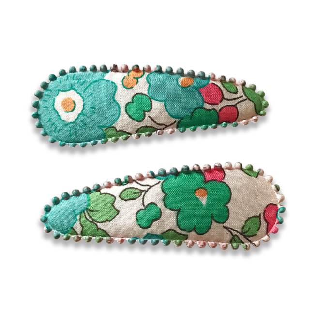 US stockist of Josie Joan's Kylie set of two fabric hair clips.  Cream colored fabric with blue, green flowers and red, yellow berries. Features scalloped edges.
