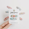 US stockist of Josie Joan's Little Kylie set of two fabric baby hair clips.  Cream colored fabric with blue, green flowers and red, yellow berries. Features scalloped edges.