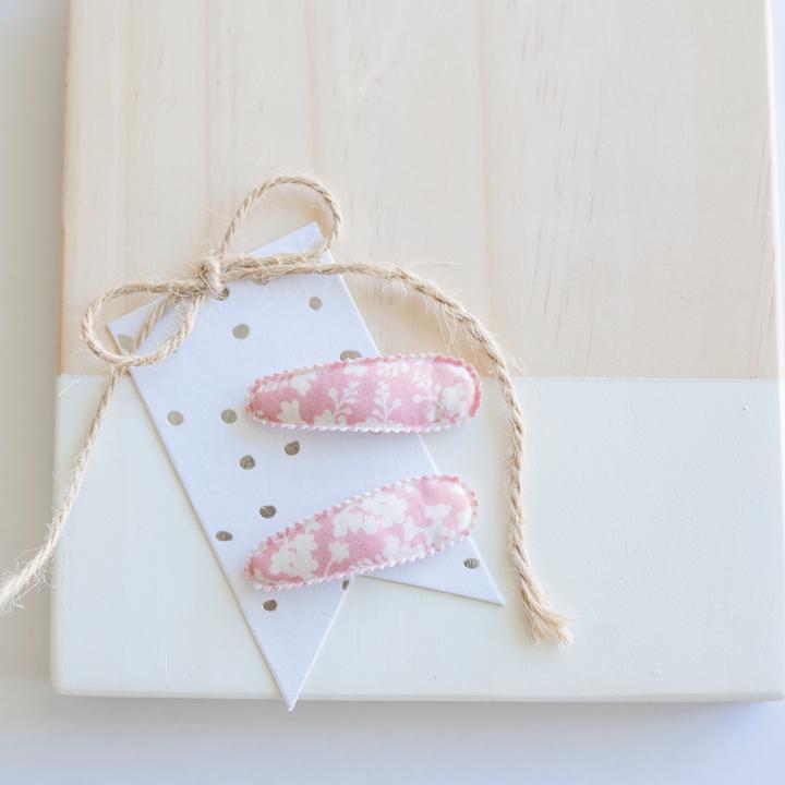 US stockist of Josie Joan's Little Mazi set of two fabric covered baby hair clips.  Gorgeous pink fabric with contrasting pale flowers and leaves.  Scalloped edging.