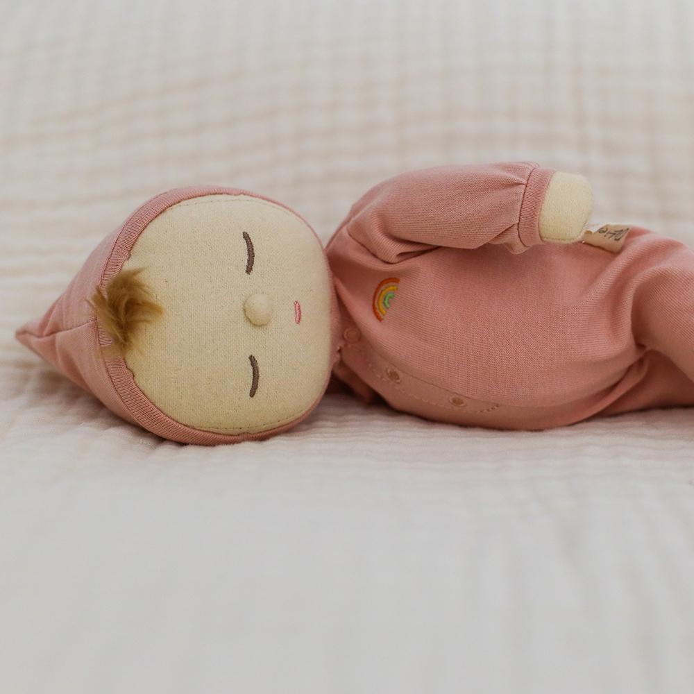 US stockist of Olli Ella's gender neutral, Moppet Dozy Dinkum.  Features tuft of blond hair with non removable hooded pink onesie.
