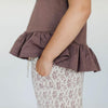 US stockist of Buck & Baa's organic cotton peplum top in plum.  Features short sleeves and black daisy print on front.
