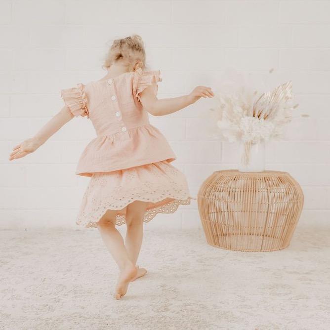 US stockist of India and Grace's Embroidered Ruffle Peplum Top in vintage pink.  Made from cotton with shell buttons at the back, ruffle sleeves and floral embroidery on the chest. 