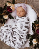 US stockist of Snuggle Hunny Kid's white cotton jersey wrap with brown quill feather print. Comes with matching beanie.