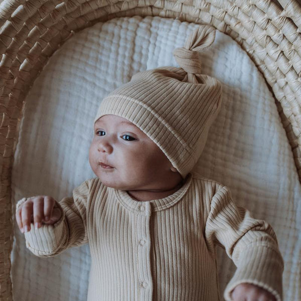 US stockist of Buck & Baa's gender neutral, organic cotton ribbed knotted hat in Biscuit.