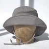 US stockist of Fini the Label's gender neutral, sailor swim hat in mushroom. Features elongated back for added sun protection, wide brim and chin strap. Brim is medium stiffness and can be flipped up at front. Sides can be worn buttoned up for that sailor look.  Made from nylon/spandex and is quick drying.
