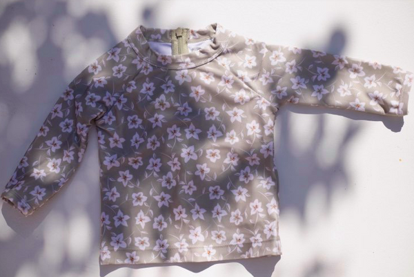 US stockist of Sukoo the Label's long sleeve Belle Rash Top. Made from UPF 50 + Repreve fabric with an all over floral print and invisible zip at back.  Pairs with frill bottoms, sold seperately.
