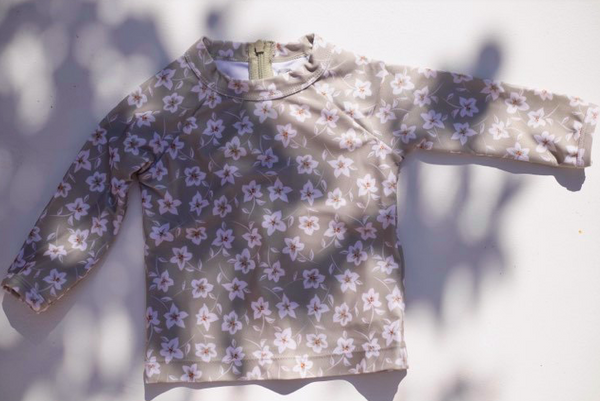 US stockist of Sukoo the Label's long sleeve Belle Rash Top. Made from UPF 50 + Repreve fabric with an all over floral print and invisible zip at back. Pairs with frill bottoms, sold seperately.