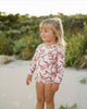 US stockist of Sukoo the Label.  Long Sleeve rashsuit made from Repreve UPF 50 + fabric.  Cream fabric with beautiful pink floral print and hidden zip at back.