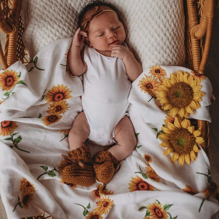 US stockist of Snuggle Hunny Kid's organic muslin wrap.  White with sunflower print.  Measures 47" x 47".