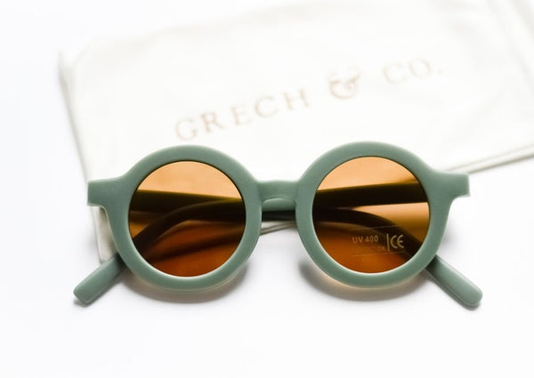 US stockist of Grech & Co's gender neutral sustainable sunglasses.  Made from recycled plastic, with round amber lens with UV 400 protection in a fern green color.