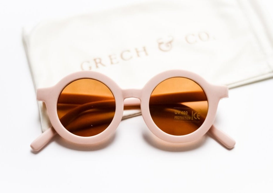US stockist of Grech & Co's gender neutral sustainable sunglasses.  Made from recycled plastic, with round amber lens with UV 400 protection in a shell color.