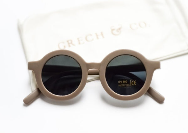 US stockist of Grech & Co's gender neutral sustainable sunglasses.  Made from recycled plastic, with round grey lens with UV 400 protection in a stone grey color.