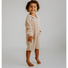 US stockist of Illoura the Label's gender neutral, Essential Knit Romper in Biscuit.  Made from 100% rib cotton with coconut buttons on placket and a collar.