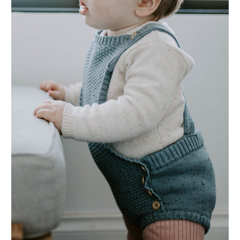 US stockist of Miann & Co's slate blue knit overalls. Gender neutral, made from 100% cotton with decorative wooden buttons.