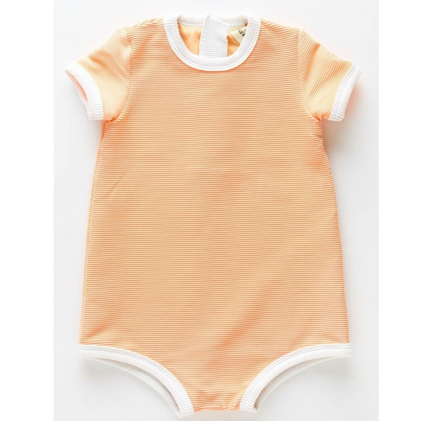 The US stockist of Zulu & Zephyr Mini Rib Onesie in Grapefruit.  A loose fit gender neutral style made from sustainable ECONYL UPF 50+ fabric.  Short sleeved with contrasing back zipper and binds.  Fully lined.