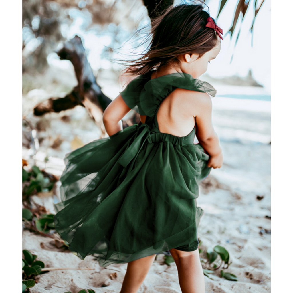 US stockist of Karibou Kid's Scarlett Tutu Dress in Emerald Green.  Made from a soft cotton blend with midi length tulle skirt.  Features open back with a big bow.