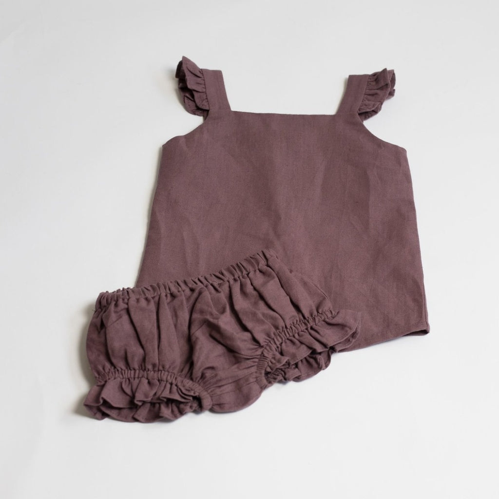 US stockist of Five O' Six's Jacquard Weave Frill Set in a deep plum color.  Made from organic linen.