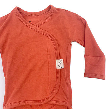 Stockist of Bonsie's rayon blend sunset red footie.  Top section has velcro wrap body which can be undone for skin to skin contact.  Elastic waist that can be pulled down for easy diaper changes. 