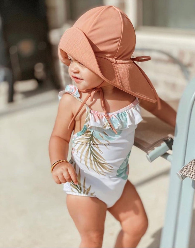 US stockist of Fini the Label's gender neutral, floppy swim hat in cocoa. Features elongated back for added sun protection, chin strap and adjustable bow around crown for better fit. Brim is medium stiffness and can be flipped up at front.  Made from nylon/spandex and is quick drying.