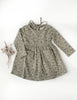 US stockist of Karibou Kid's Long Sleeve Cotton Puff pocket dress in sage green. Featues two front pockets and ties at back of neck.