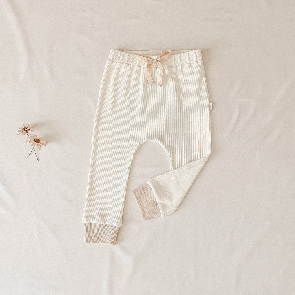 US stockist of India + Grace The Label's relaxed fit, gender neutral ribbed cotton leggings in cream.  Features contrasting hazelnut cuffs and non functional drawstring at waist.