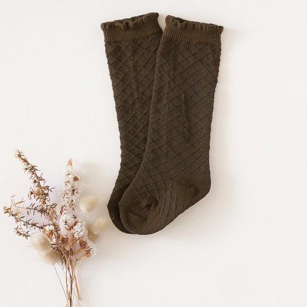 US stockist of Karibou Kid's Midnight Olive cotton socks. Warm dark olive color with mesh texture and frill at top. Cotton blend.