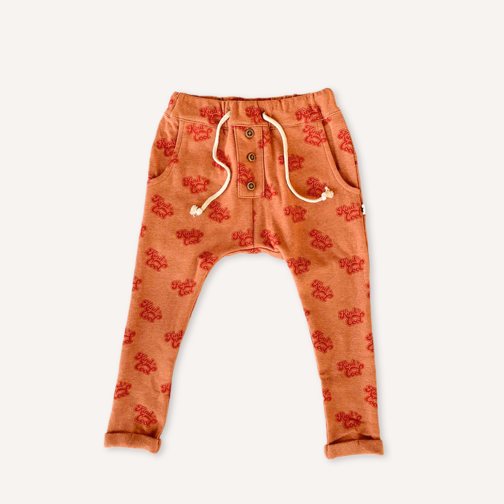 US stockist of My Brother John's Ziggy long john pants. Made in warm orange fabric with cozy fleecy lining, drop crotch, pockets, functional drawstring at waist and decorative buttons down the front.