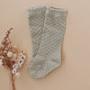 US stockist of Karibou Kid's Conifer cotton socks. Dusty sage green color with mesh texture and frill at top. Cotton blend.