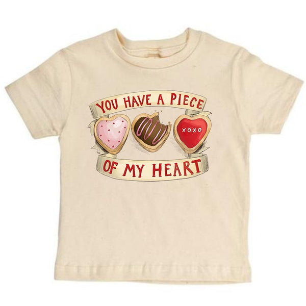 Stockist of Raising Tito.  Cream short sleeve t-shirt made from organic cotton.  Has a print of 3 heart shaped cookies on front with "you have a piece of my heart" printed top and bottom.