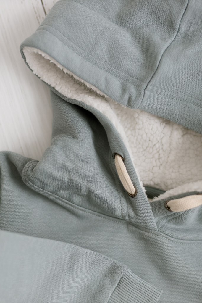 US stockist of Five O' Six's organic cotton, gender neutral hooded sweatshirt in Slate.  Features sherpa lined hooded for added warmth and comfort.
