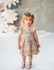 US stockist of Karibou Kids cotton Wild Meadow sunshine dress.  In muted florals, with pretty flutter sleeves, adjustable straps and an open back.