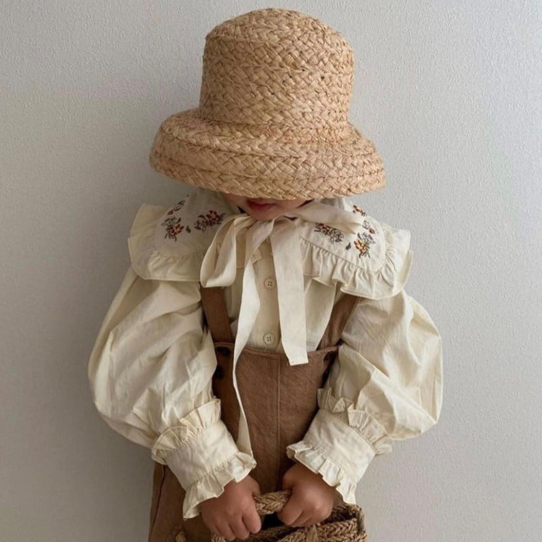 US stockist of Fini the Label's vintage French style straw hat.  Made from raffia straw with a wide bell shaped brim and a trimmed natural ribbon beget chin strap.
