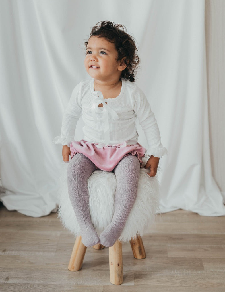 US stockist of Karibou Kids' whimsy love ruffle sleeve, cotton waffle top in snow white.  Features keyhole tie front of neck.