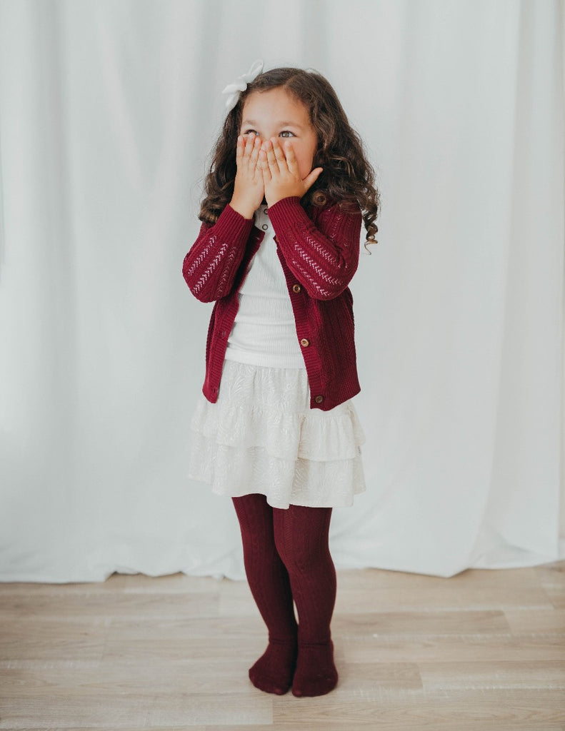 US stockist of Karibou Kids' Rosie Cozy Cable Knit Tights in Plum.  Made from a stretch cotton blend.